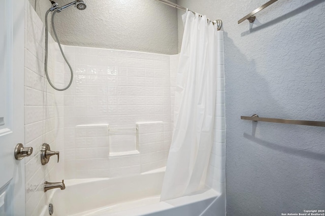 bathroom featuring a textured wall and shower / bath combo with shower curtain