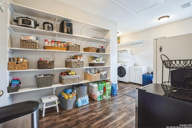 storage area with visible vents and separate washer and dryer