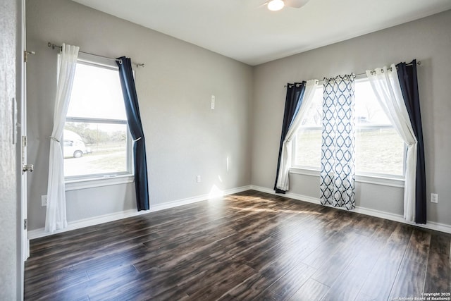 empty room with baseboards and wood finished floors