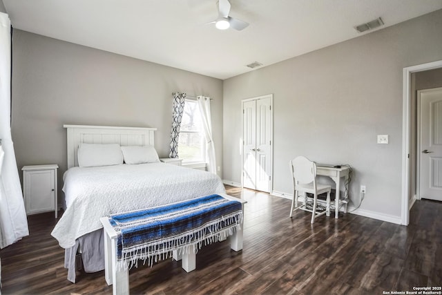 bedroom with wood finished floors, visible vents, and baseboards