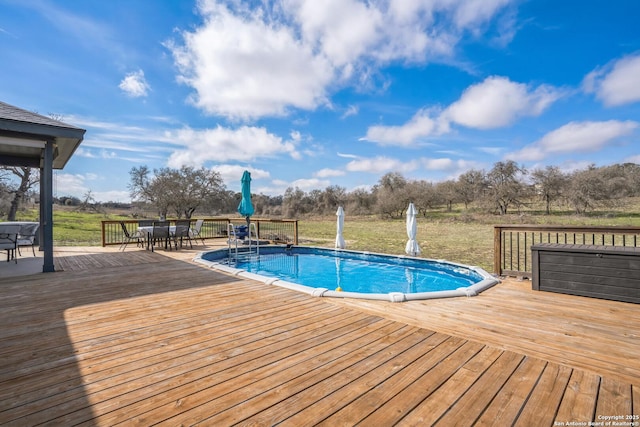 pool featuring outdoor dining area and a wooden deck