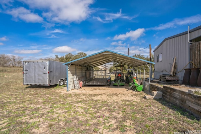 view of yard featuring a carport, an outbuilding, and a storage shed