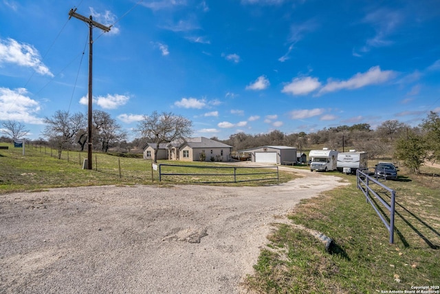 view of front of house featuring a front yard, fence, and driveway