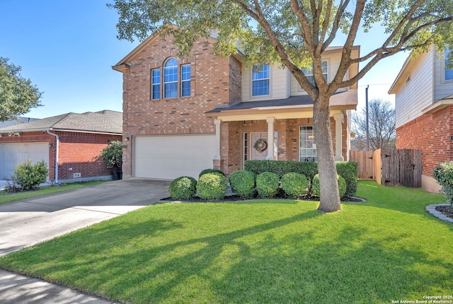 traditional-style home featuring brick siding, an attached garage, fence, driveway, and a front lawn