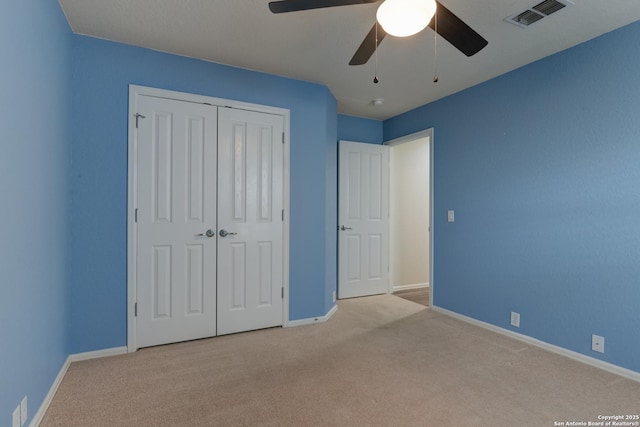 unfurnished bedroom with visible vents, baseboards, a closet, and carpet flooring