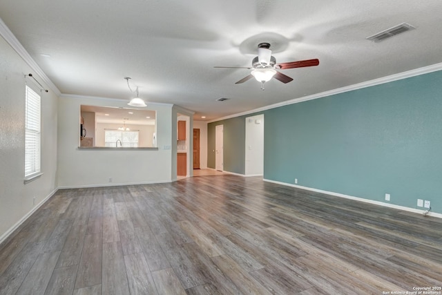 unfurnished living room with visible vents, baseboards, wood finished floors, and a ceiling fan