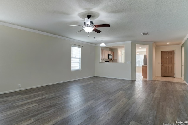 unfurnished living room featuring visible vents, dark wood-type flooring, a textured ceiling, crown molding, and ceiling fan