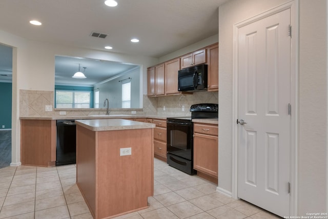 kitchen featuring visible vents, a kitchen island, a sink, black appliances, and light countertops