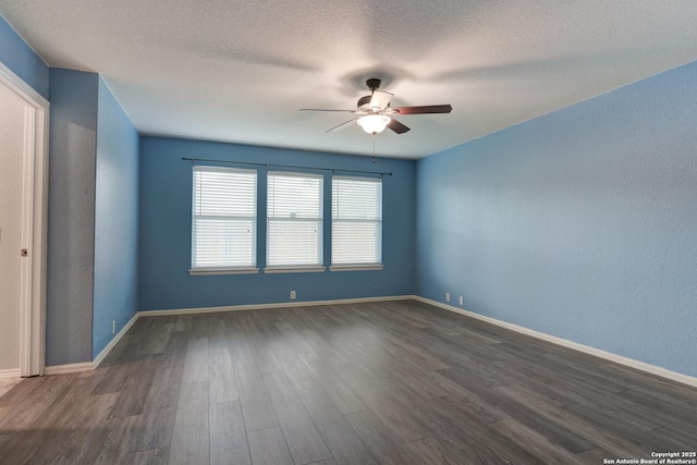 unfurnished room featuring dark wood-style floors, a textured ceiling, baseboards, and ceiling fan