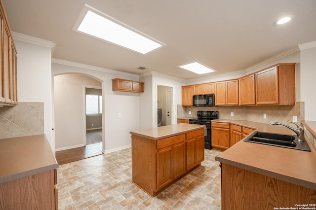 kitchen featuring arched walkways, a sink, backsplash, black appliances, and crown molding