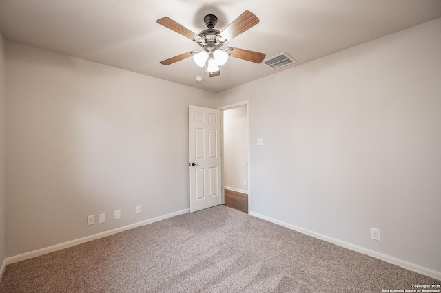 unfurnished room featuring baseboards, visible vents, ceiling fan, and carpet flooring