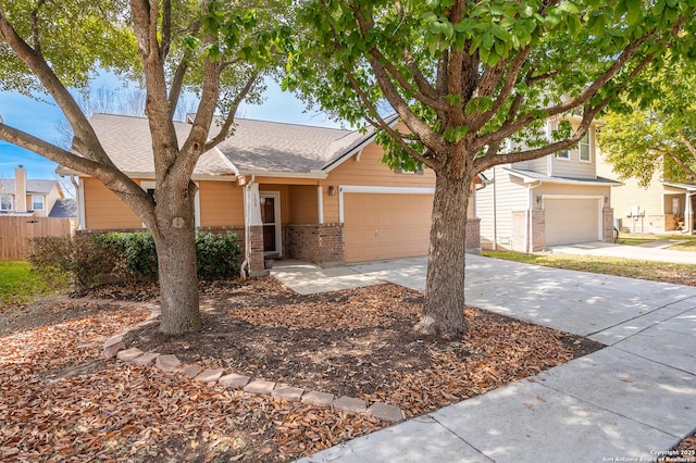 view of front of property with driveway, a garage, a shingled roof, fence, and brick siding