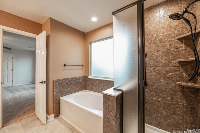 bathroom with a shower stall, baseboards, and a bath