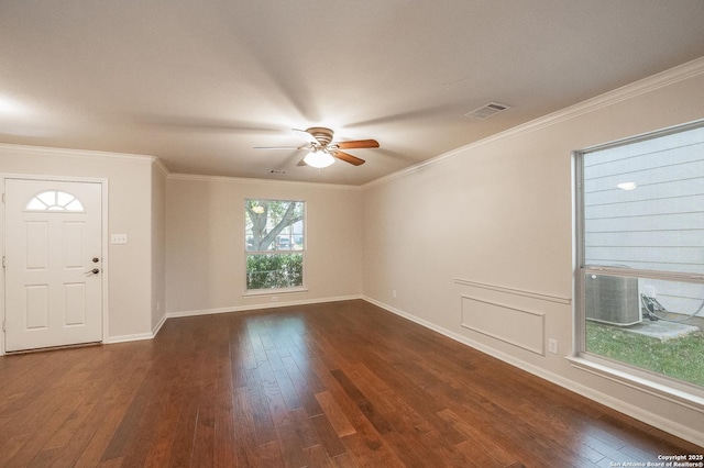 foyer featuring ornamental molding, dark wood-type flooring, visible vents, and baseboards