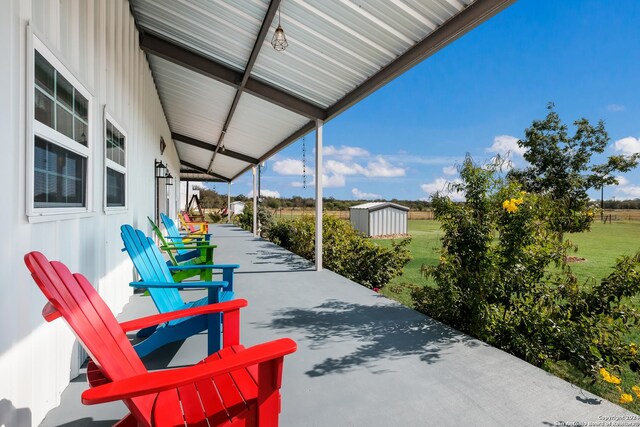 view of patio with a storage shed and an outdoor structure