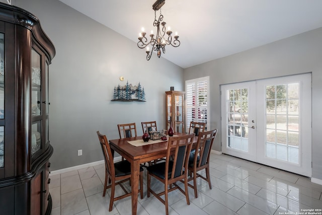 dining space featuring lofted ceiling, light tile patterned flooring, baseboards, french doors, and an inviting chandelier