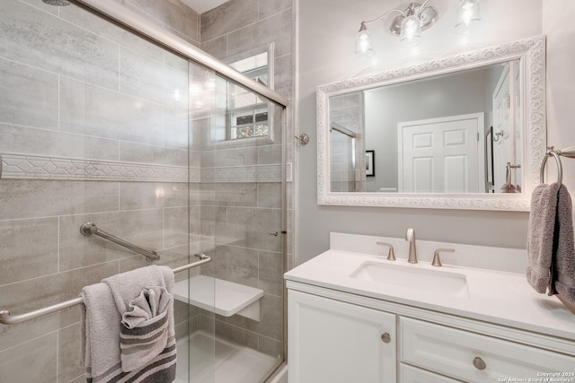 bathroom featuring a shower stall and vanity