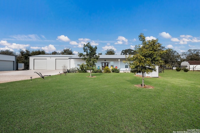 view of front of property with a garage and a front yard