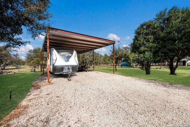 view of car parking with driveway and a carport