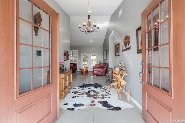 foyer featuring baseboards and an inviting chandelier