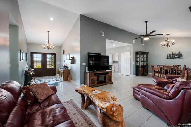 living room featuring light tile patterned floors, visible vents, baseboards, and high vaulted ceiling