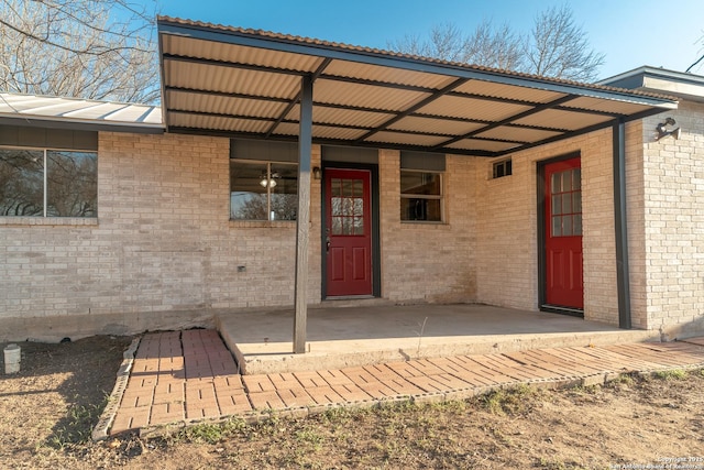 view of exterior entry with brick siding