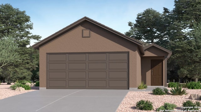 view of front of home featuring an attached garage, concrete driveway, and stucco siding