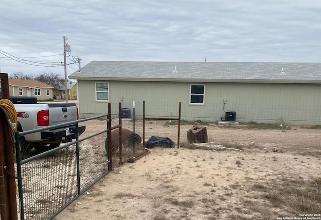 view of side of property with fence and central air condition unit