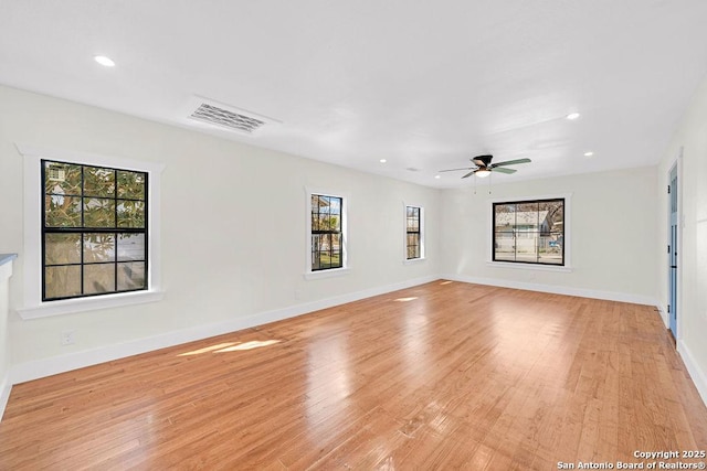 unfurnished room featuring baseboards, light wood finished floors, visible vents, and recessed lighting