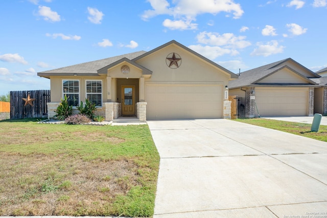 view of front of property with driveway, an attached garage, fence, a front yard, and stucco siding