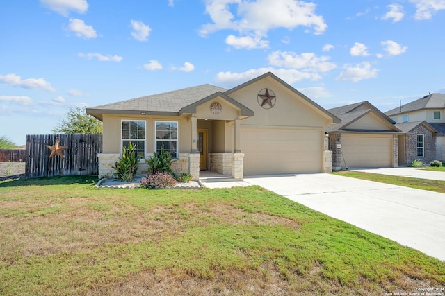 view of front of home with stucco siding, fence, a garage, driveway, and a front lawn