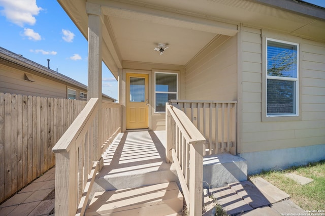 view of exterior entry featuring fence