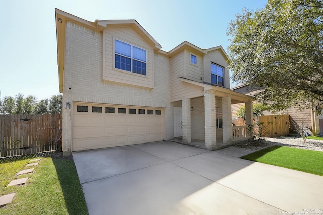 view of front of home featuring an attached garage, driveway, fence, and brick siding