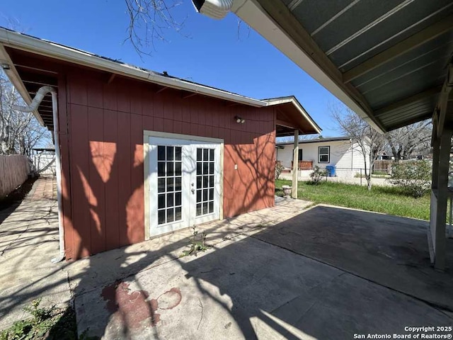 rear view of property featuring a patio, french doors, and fence