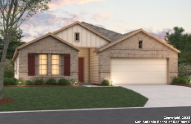 view of front of property with an attached garage, concrete driveway, and a yard