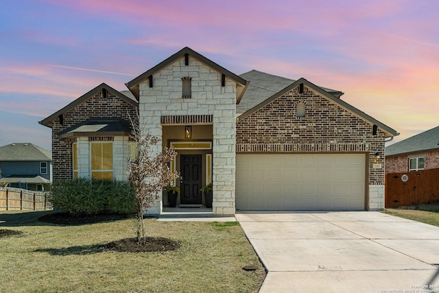 french country style house featuring brick siding, concrete driveway, fence, a garage, and stone siding