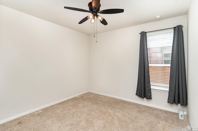 empty room featuring a ceiling fan, baseboards, and carpet flooring