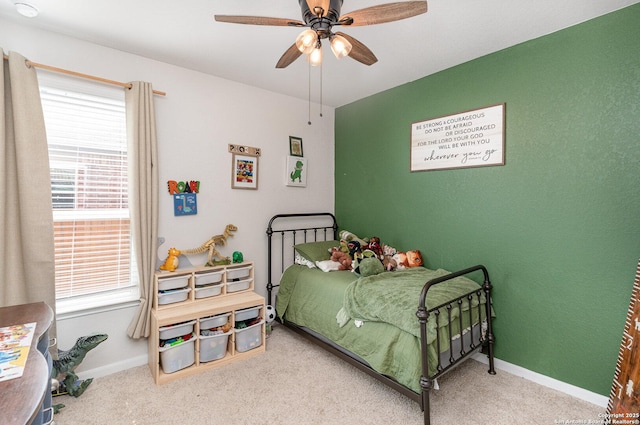 bedroom with ceiling fan, carpet flooring, and baseboards