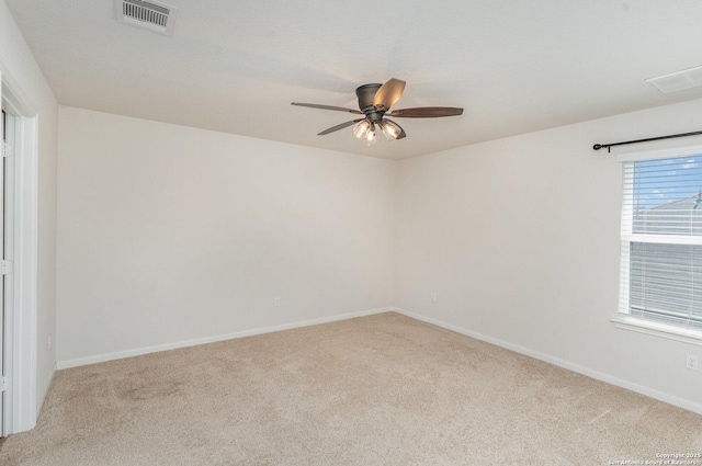 unfurnished room with baseboards, visible vents, a ceiling fan, and light colored carpet