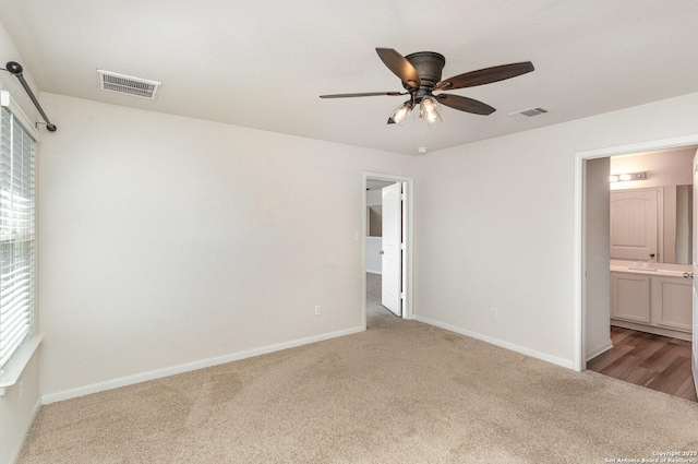 unfurnished bedroom featuring carpet, visible vents, and baseboards