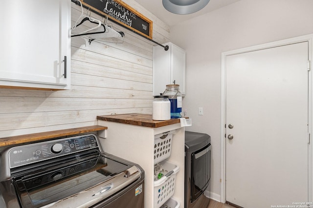 laundry area featuring washer and dryer and cabinet space