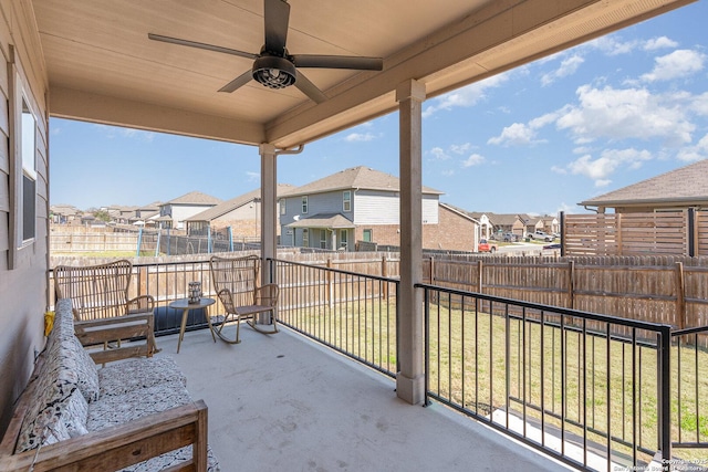 balcony featuring ceiling fan and a residential view