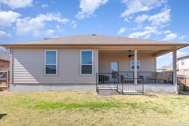 rear view of house with a patio, fence, a ceiling fan, and a yard