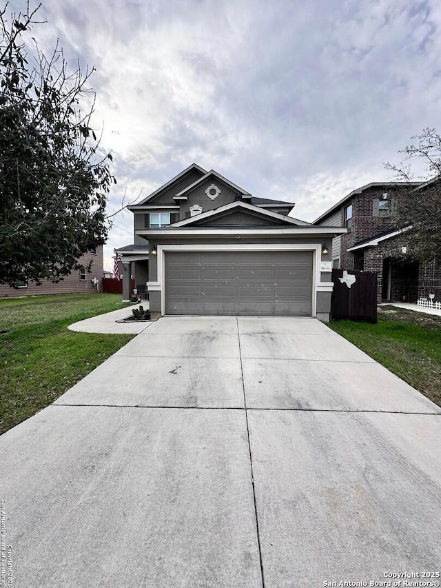 view of front of property featuring driveway, a front lawn, and an attached garage