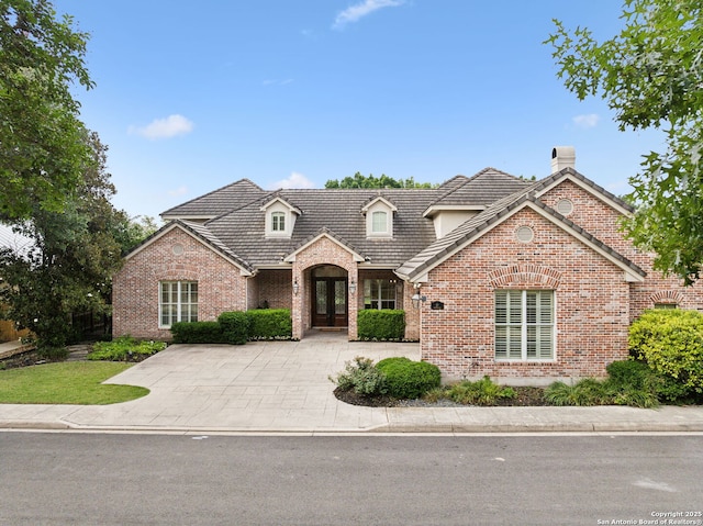 37 Westerleigh, San Antonio, TX 78218 - view of front of house with brick siding, a chimney, and french doors