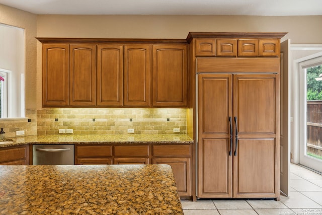 37 Westerleigh, San Antonio, TX 78218 - kitchen featuring paneled fridge, light tile patterned floors, decorative backsplash, and stone countertops