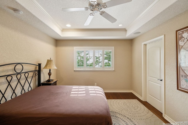 37 Westerleigh, San Antonio, TX 78218 - bedroom featuring a tray ceiling, ornamental molding, dark wood-type flooring, a textured wall, and a ceiling fan