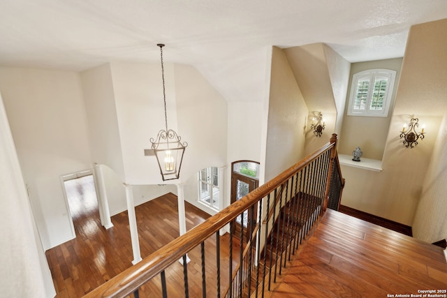 37 Westerleigh, San Antonio, TX 78218 - staircase with wood finished floors, a chandelier, vaulted ceiling, and baseboards