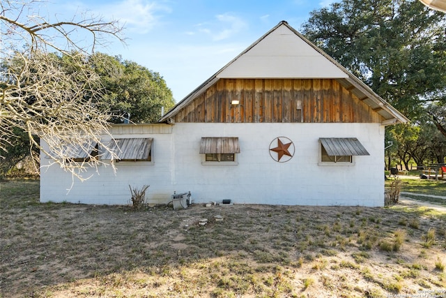 view of side of home with concrete block siding