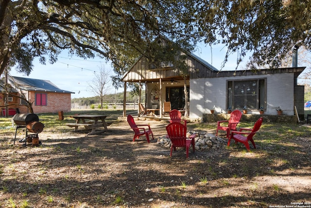 exterior space featuring a fire pit, a patio area, and a ceiling fan